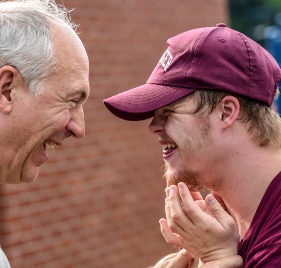 Two men smiling at each other