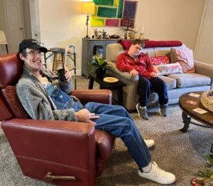 smiling adults sitting in a living room